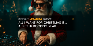 Santa Claus wearing sunglasses and headphones while DJing at a club with Christmas lights in the background.