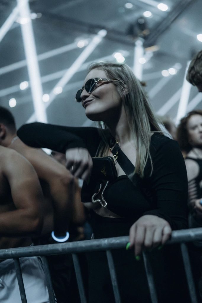 Founder of Gigevate dancing at an electronic music event with club lights in the background.