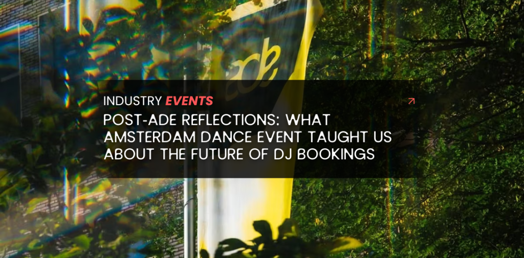A crowd walking through Amsterdam during ADE with yellow ADE flags and event energy in the air.